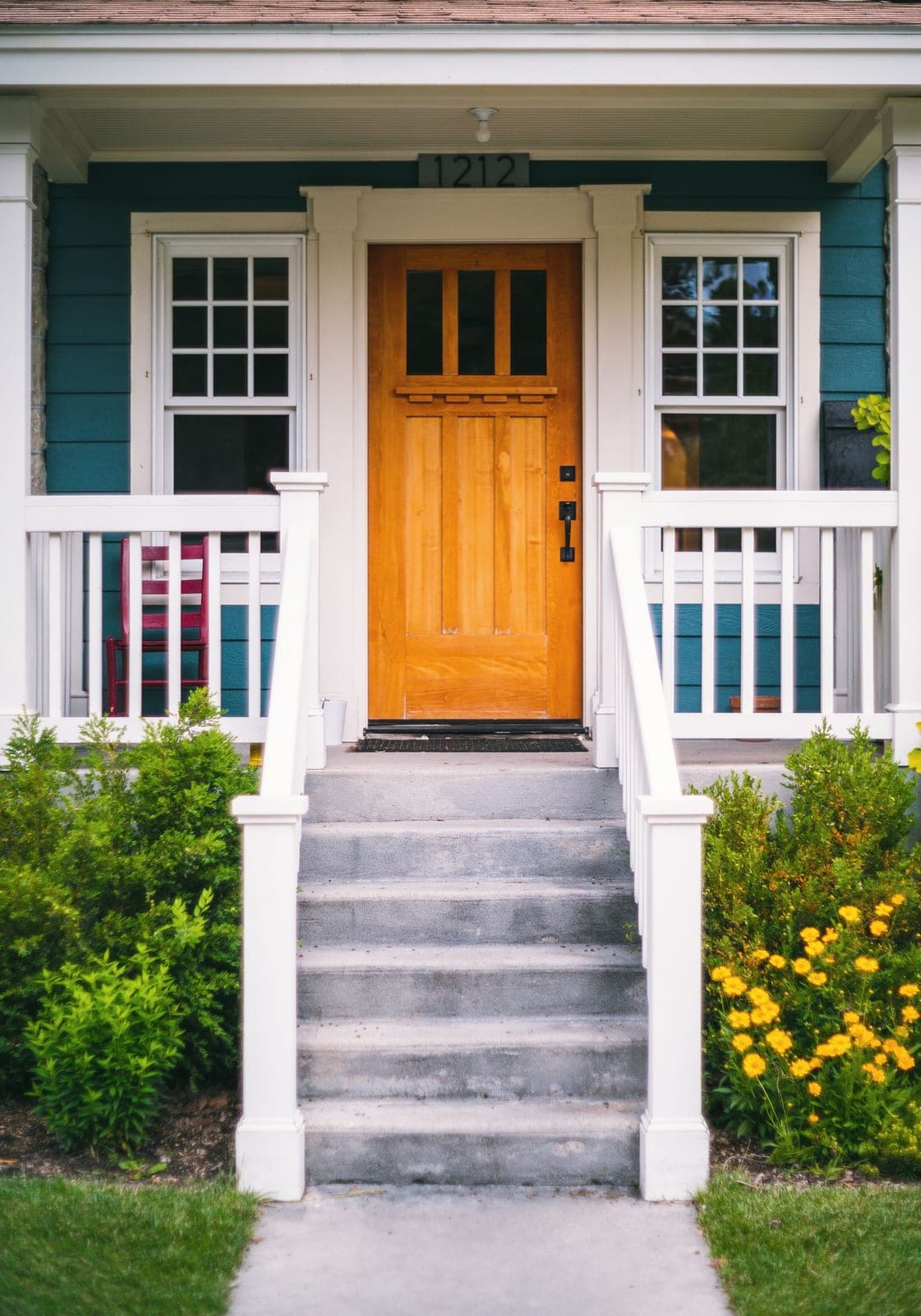 Entry door replacement in Red Deer: wood front door with glass panes at the top of porch steps