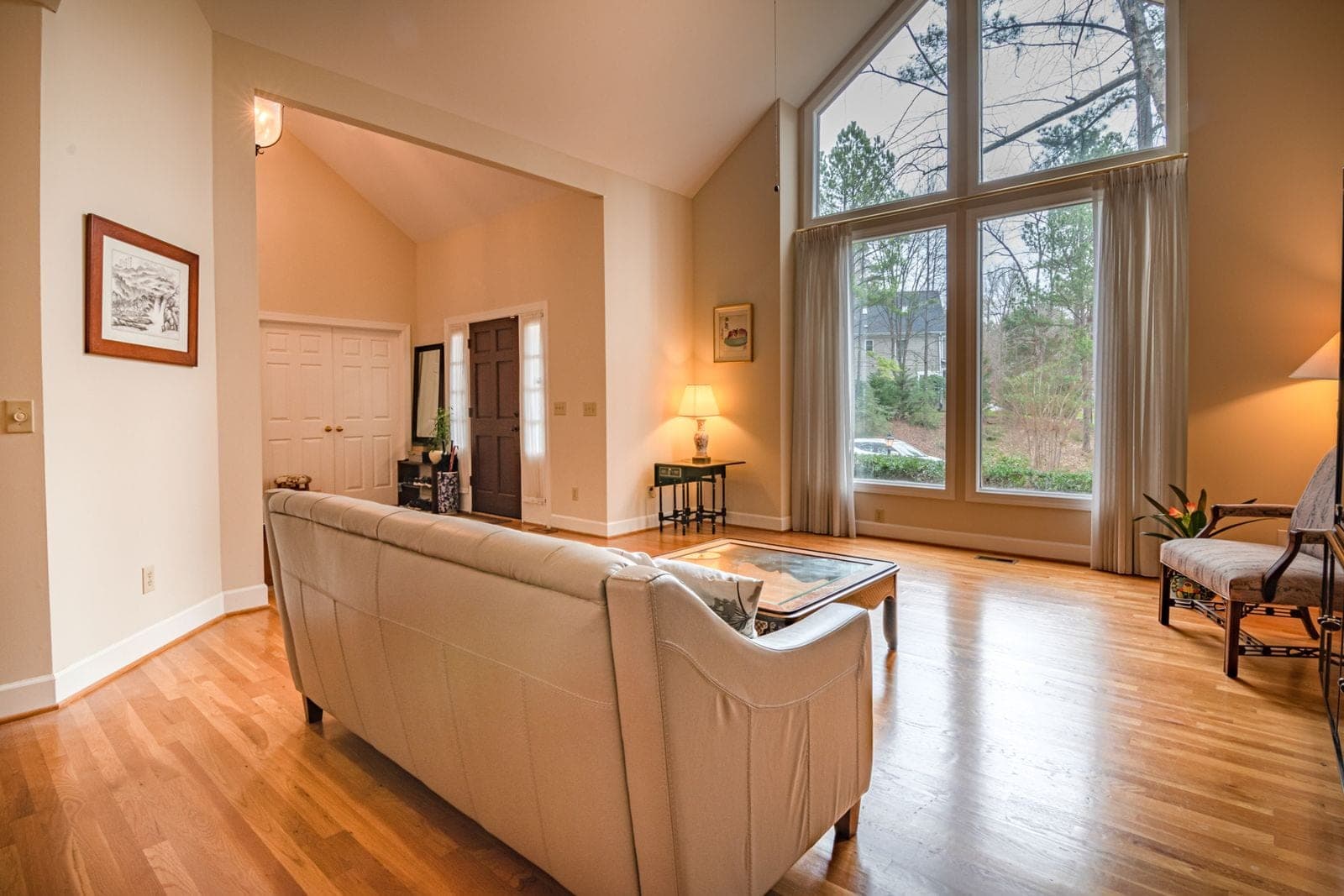 About Red Deer Custom Windows: living room with tall windows under a vaulted ceiling