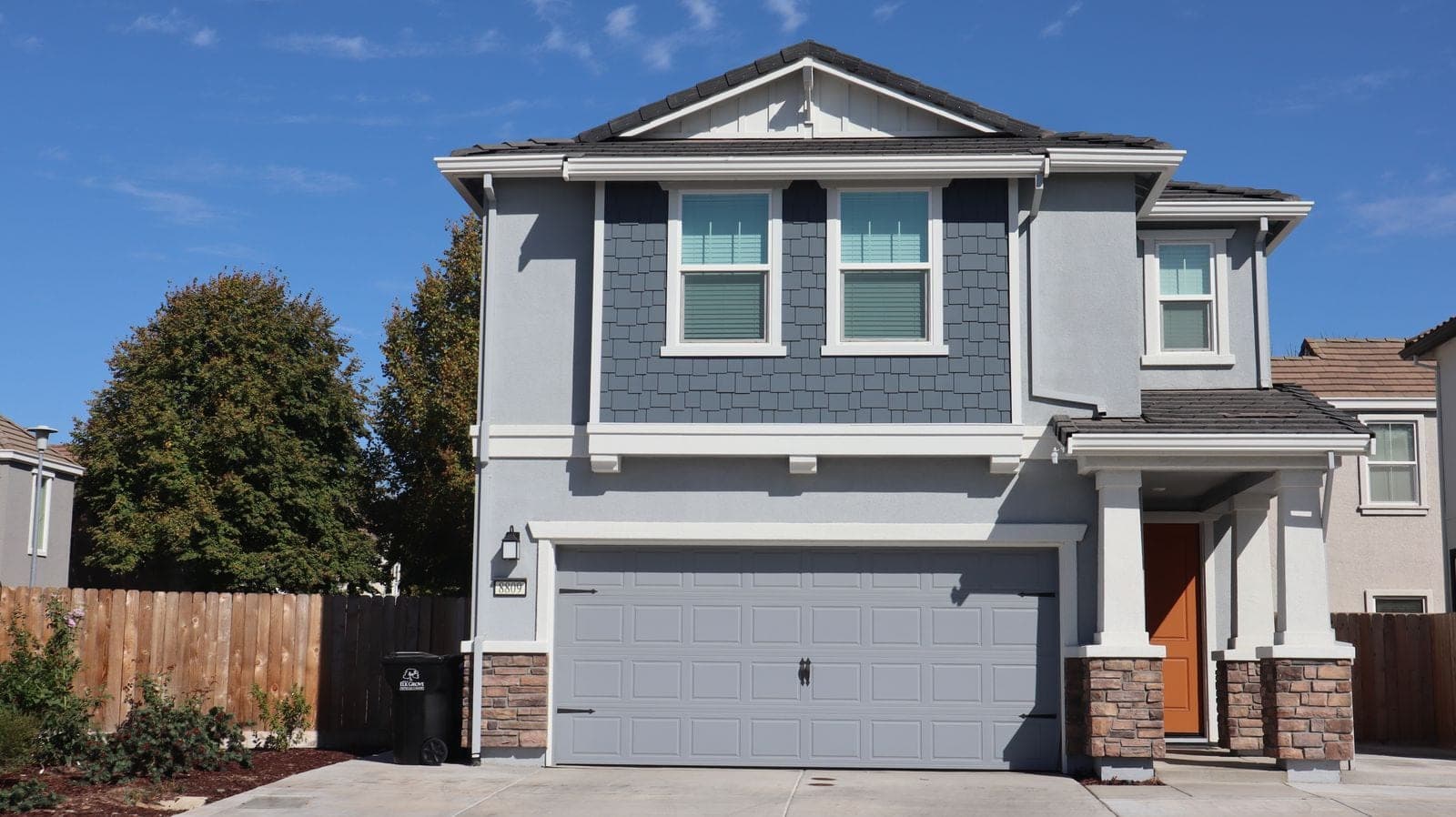 Window replacement in Blackfalds: newer two-storey house with white windows and a front garage
