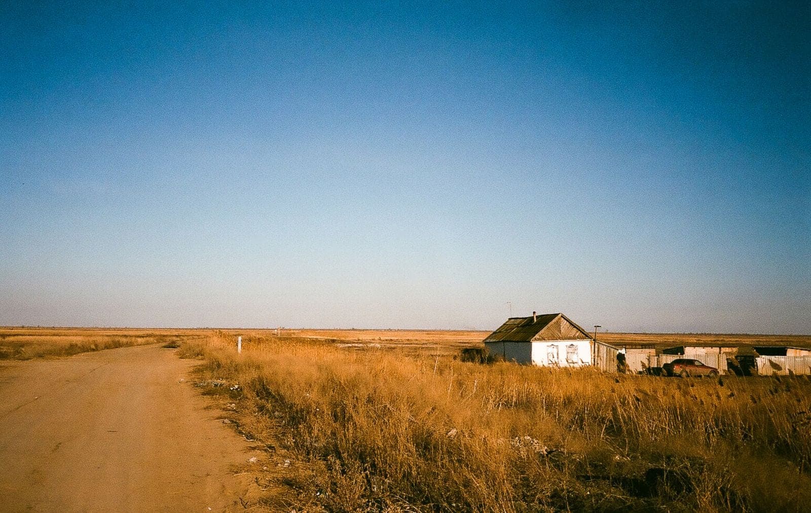 Window replacement in Rimbey: farmhouse on open prairie at the end of a dirt track