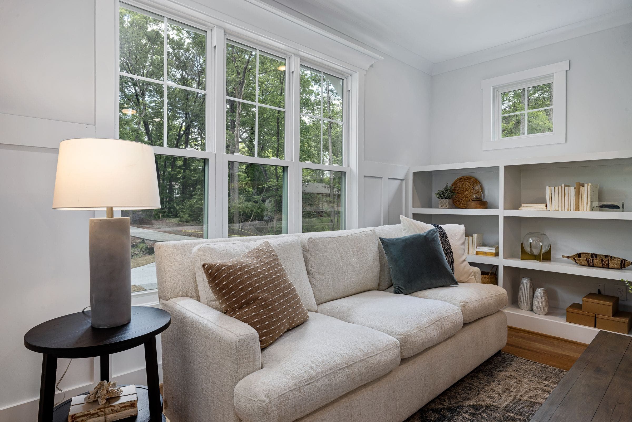 Window replacement services in Red Deer: bright sitting room with tall multi-pane windows