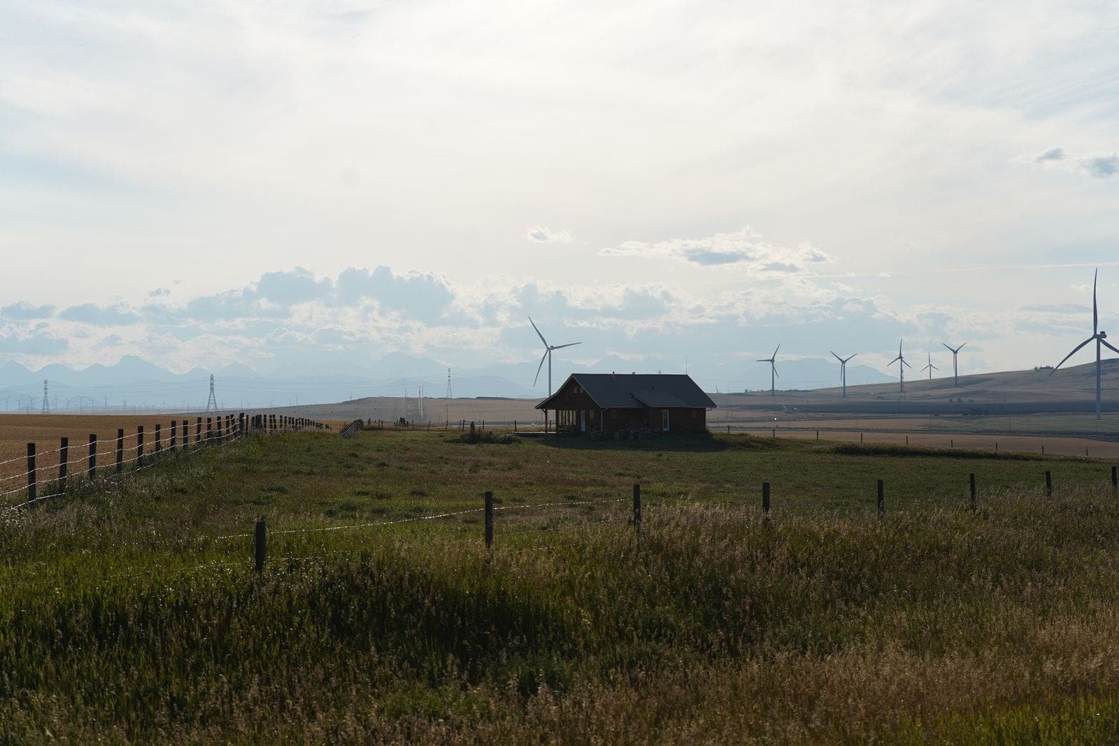 Window replacement in Stettler: small house on flat open prairie with wind turbines far off